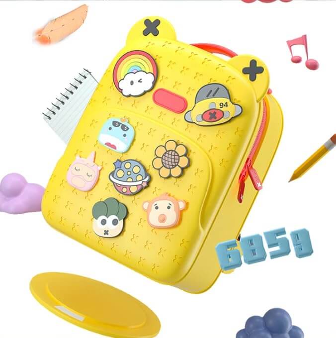 Front view of a fun, customizable silicone waterproof school bag for children, featuring a vibrant yellow color and various playful detachable badges like a rainbow, sun, and animals, ideal for kindergarten or primary school students from Usmile Toys.www.usmile toys
